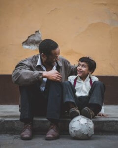 father and son, sitting, laughing