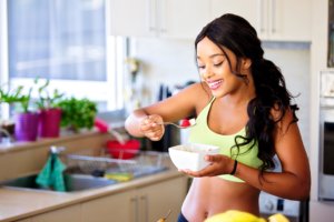 girl eating fresh fruits out of a bowl