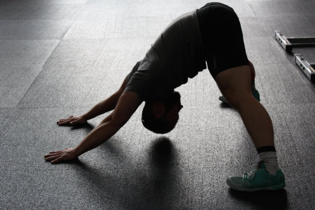 athlete stretching on the floor