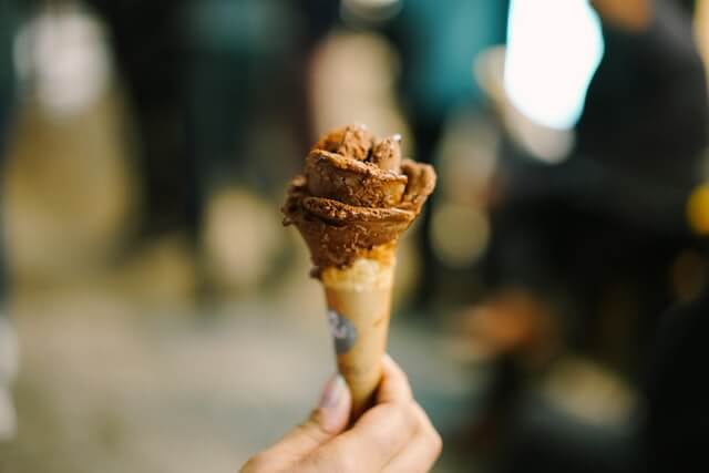 hand holding a chocolate ice cream which is also one of the best sweet treats